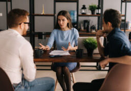 Realtor at table meeting with clients